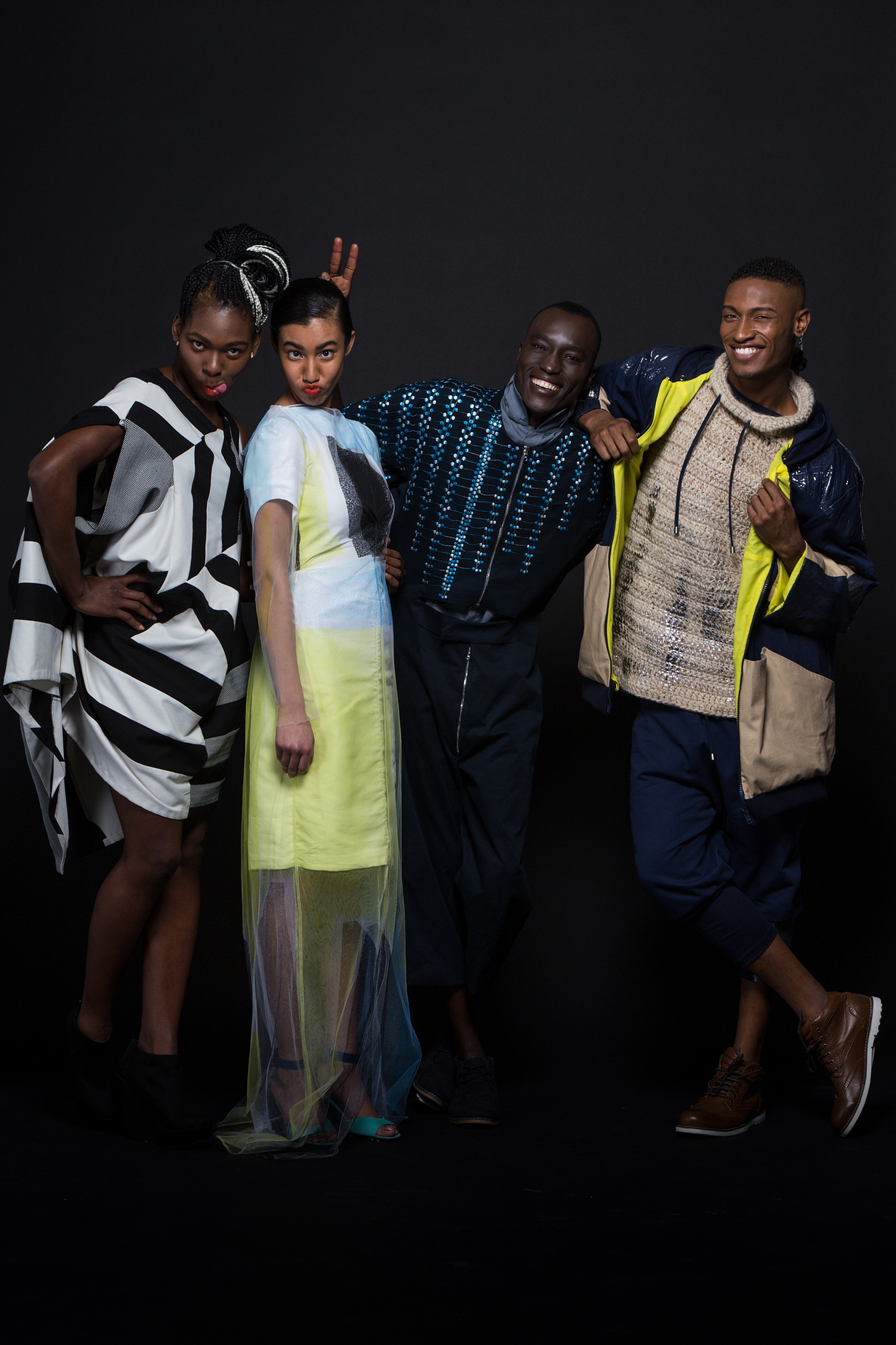 portraits of models wearing FAD creations against a black background